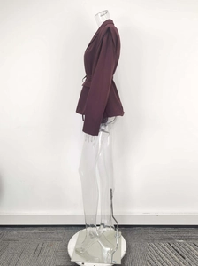 Detail of dark purple belted blazer with structured shoulders and tailored waistline
