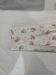 Detailed view of floral print fabric with ruched cuffs on a stylish spring blazer