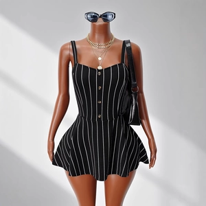 Detail of black and white striped mini dress with spaghetti straps and front buttons