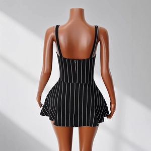 Detail of a black and white striped sleeveless mini dress with back zipper and flared hem