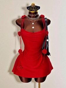 Detail of red backless mini dress with 3D floral accents and cowl neck on mannequin