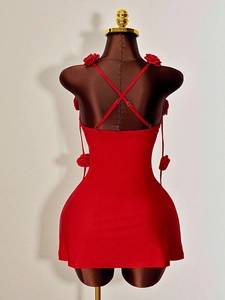 Red backless knitted mini dress featuring 3D floral accents and cross strap details