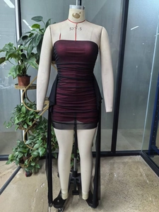 Detail view of red and black mesh ruched tube dress with elegant flowing side streamers
