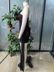 Detail of ruched mesh layers and long decorative streamers on a slim fit tube dress