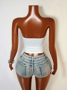 Vue arrière du haut tube blanc sexy sans bretelles et du short en jean bleu clair