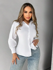 Elegant white long sleeve button down shirt paired with light blue straight jeans