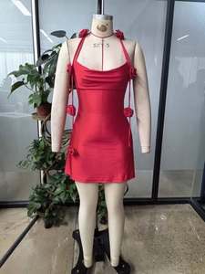 Detail of red halter mini dress featuring 3D handmade roses and cowl neck design