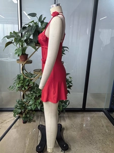 Detailed close-up of a red halter dress featuring 3D rose floral appliques on knitted fabric