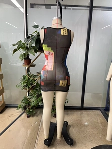 Detail view of the back of a sleeveless mesh mini dress with Chinese character print