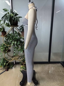 Side view of slim fit tube top jumpsuit featuring classic black and white stripes