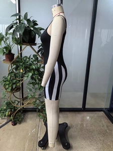 Side view detail of a black and white striped bodysuit on a mannequin with spaghetti straps