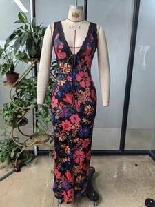 Detail of floral maxi dress featuring a V-neckline with black lace trim and drawstring ties