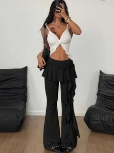 Women black flare pants with skirt overlay and white V-neck crop top outfit