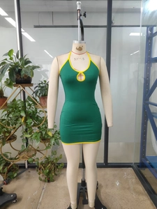 Detail of green bodycon mini dress with yellow trim and teardrop cutout neckline