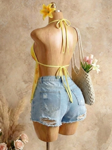Chic halter neck top with yellow floral print and distressed denim shorts summer set