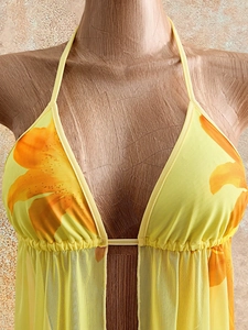 Women's yellow halter neck mesh top with floral print and open back tie design