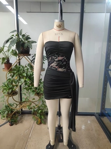 Detailed view of black tube dress featuring floral lace patchwork and side ruching