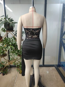 Detail of black lace bodice and ruched satin fabric on a bodycon mini tube dress