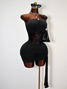 Slim fit black tube dress featuring lace cutout waist and elegant side ribbon detail