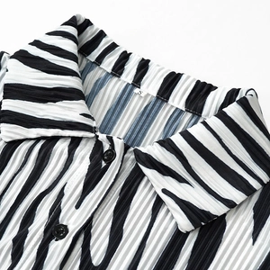 Detail of zebra print pleated shirt collar with S-size label and black buttons