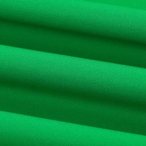 Vue détaillée de la texture du tissu tissé vert émeraude avec un drapé élégant et doux
