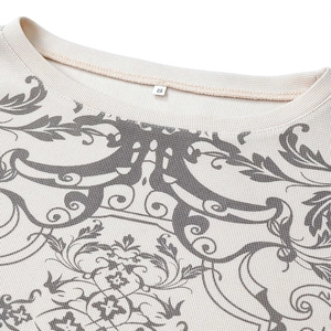 Detailed macro view of waffle knit fabric and vintage floral print on a white T-shirt