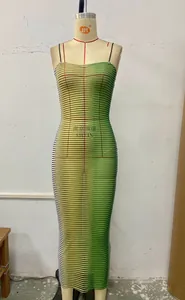 Detail of green and white striped bodycon maxi dress with thin black straps on a mannequin