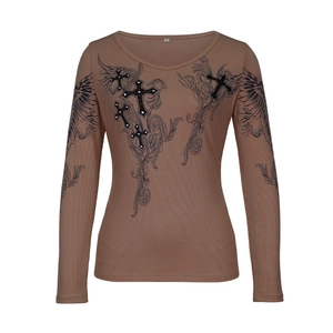 Macro detail of brown ribbed long sleeve shirt with gothic cross and wings print