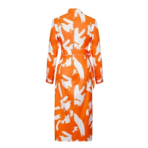 Rear view detail of orange long-sleeve maxi dress with white abstract artistic print