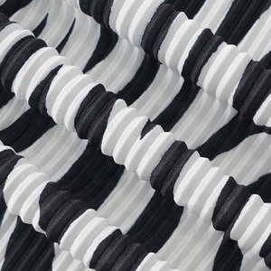 Close-up of pleated black and white zebra pattern fabric texture and material detail