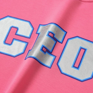 Detailed macro view of the silver metallic CEO print on pink cotton sweatshirt fabric
