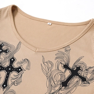 Detail of slim-fit khaki V-neck t-shirt featuring gothic cross and feather graphic print