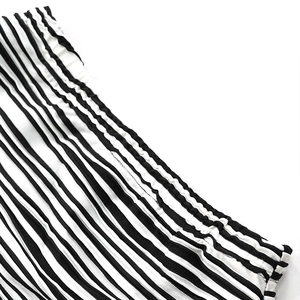 Detail of elastic waist featuring fine black and white stripes on a two-piece set
