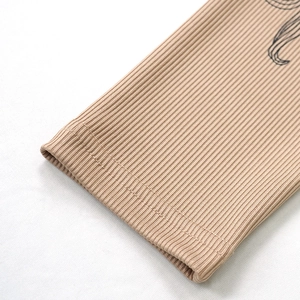 Detail of khaki ribbed knit fabric showing fine double-needle stitching and print quality