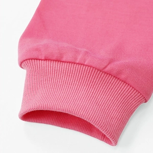 Close-up of pink cotton sweatshirt ribbed cuff showing knitting texture and quality craftsmanship