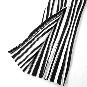 Detail of vertical black and white striped fabric showing side slit and fine stitching