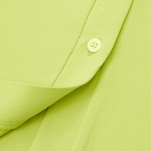 Detailed close-up of bright green knitted fabric featuring color-matched buttons and stitching