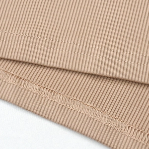 Detail of khaki rib-knit fabric showing precise hem stitching and overlock sewing technique