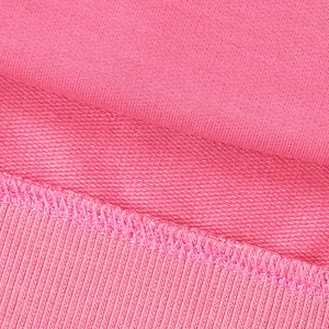 Detailed close-up of pink sweatshirt fabric showing French Terry loop and ribbed cuff