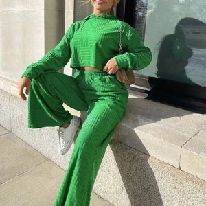 Détail du haut à capuche court et pantalon large en maille gaufrée de couleur vert vif