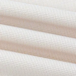 Detailed close-up showing the waffle knit texture of this cream casual t-shirt fabric