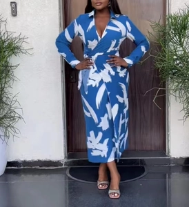 Detailed close-up of dark blue wrap dress with white artistic brushstroke print and V-neckline