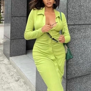 Detail of lime green long sleeve knitted dress featuring front ruching and buttoned neckline