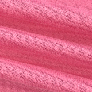 Macro shot of pink knitted fabric texture showing soft cotton blend stitching detail