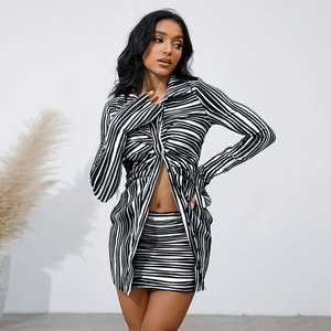 Detail of black and white wavy striped two-piece set featuring buttons and slim fit texture