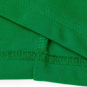 Detailed close-up showing the neat overlock stitch and hemline of the green summer set
