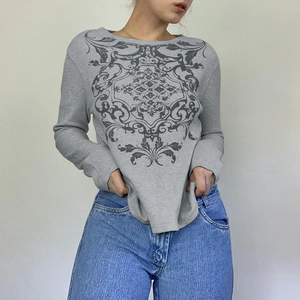 Detail of grey long sleeve t-shirt featuring gothic print and waffle knit texture