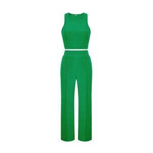 Detail view of the green sleeveless cropped tank top collar and size S woven label