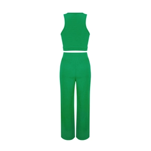 Rear view of green sleeveless crop top and high-waisted ribbed knit pants set