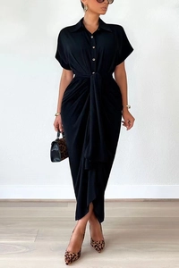 Detail of the elegant black polo collar shirt dress with waist tie and pleated texture